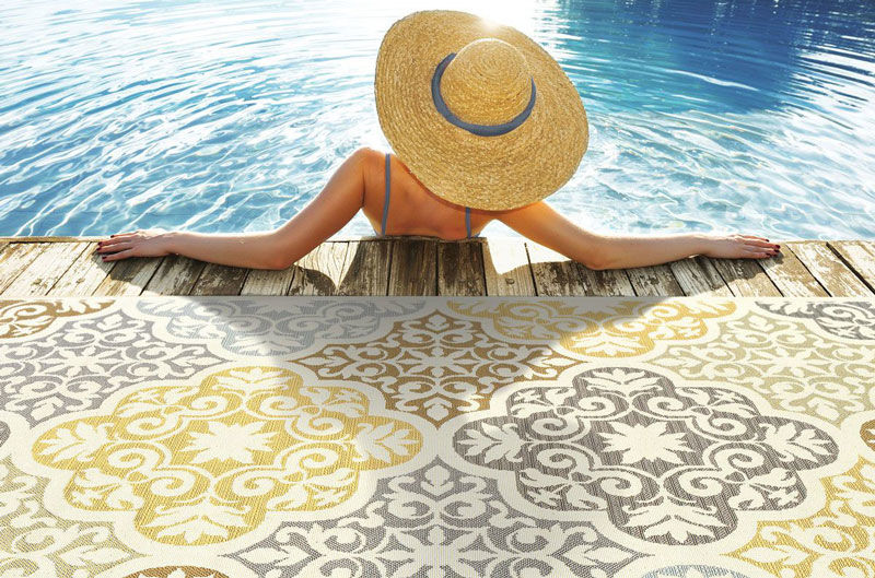 Image of woman at a pool near the Bali indoor/outdoor rug